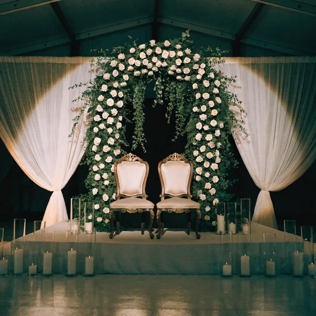 A ceremony stage in white and blush roses