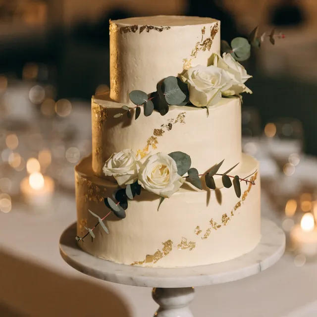 A three-tier cake with gold leaf